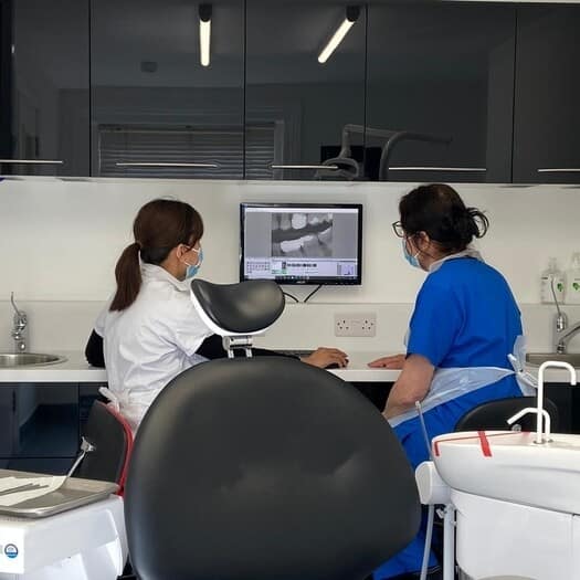 dentist looking at xray dentist in hitchin uai